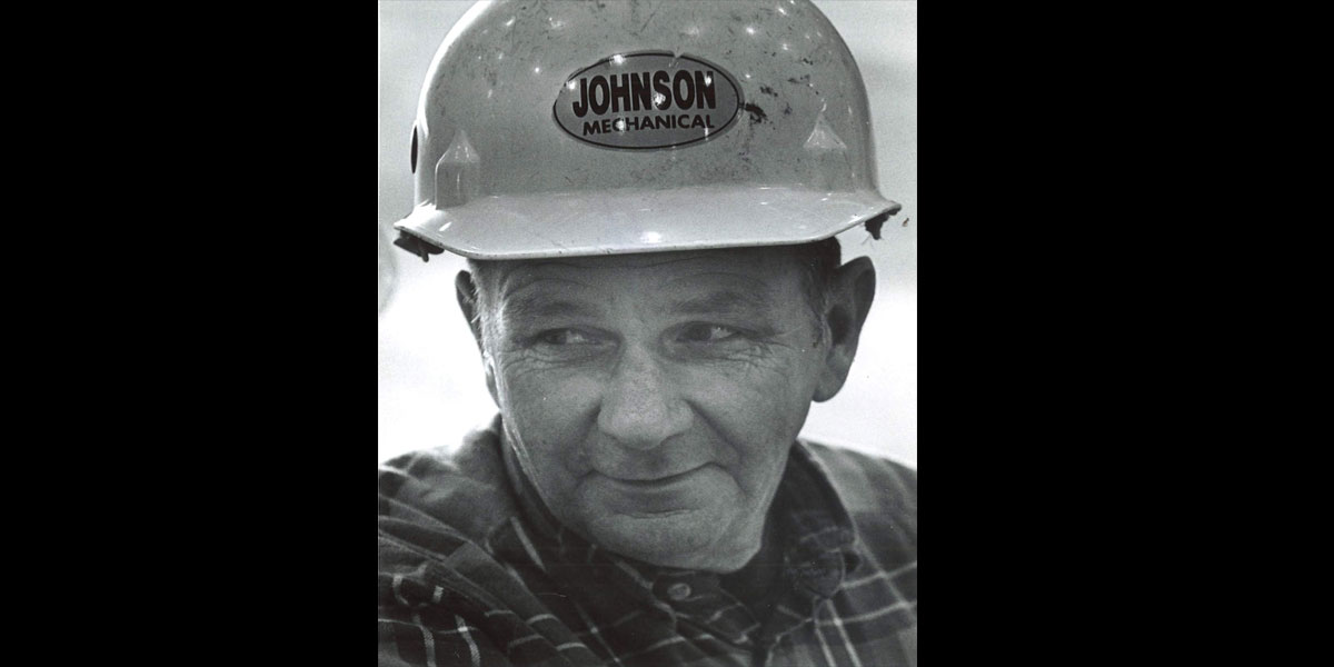 Image of worker with Johnson Mechanical hard hat.
